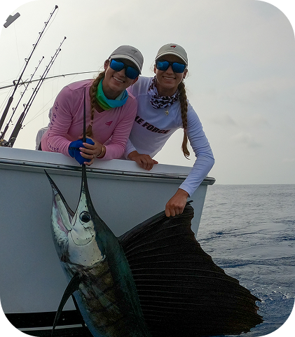 Group celebrating with a marlin